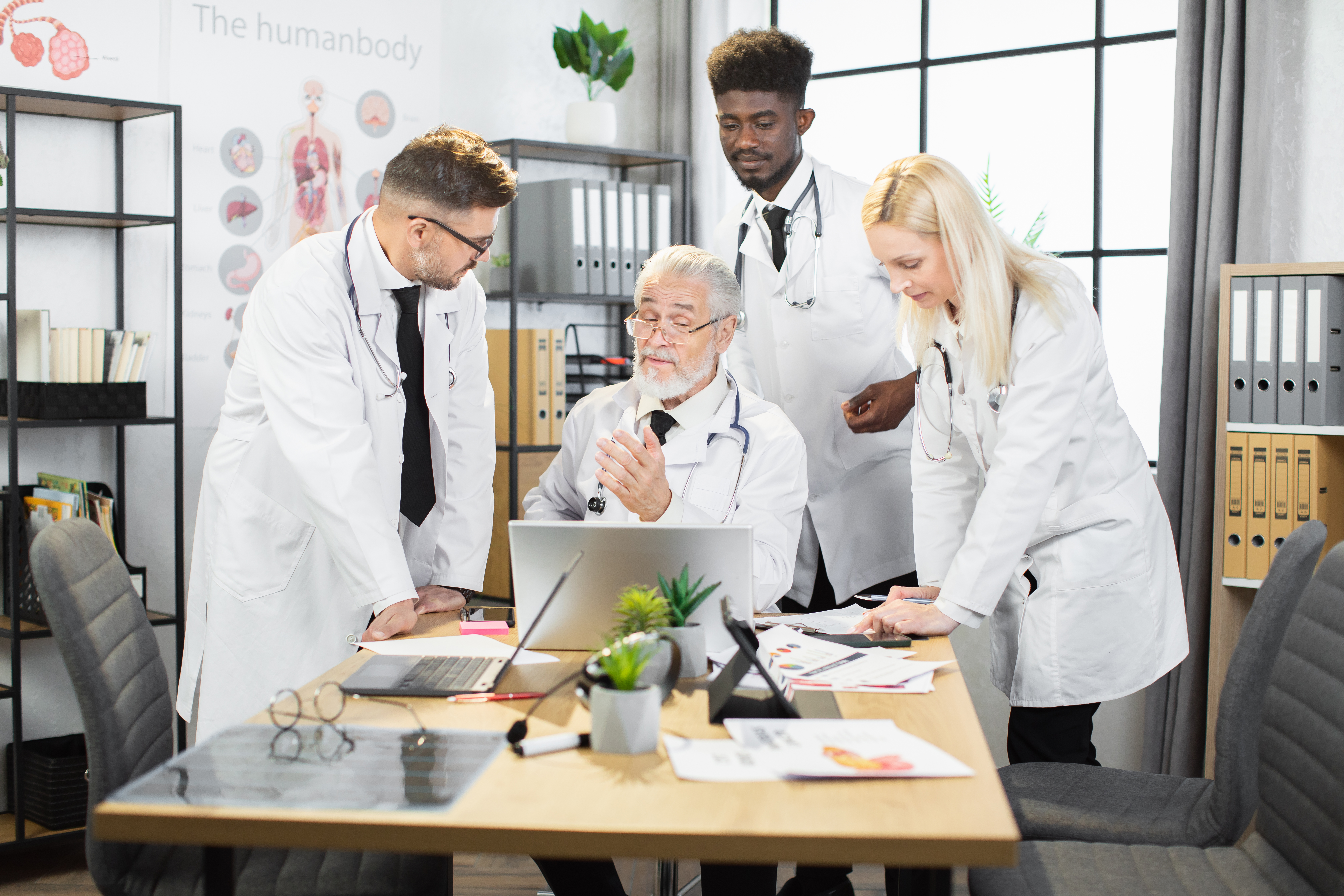 Multiracial medical workers using gadgets